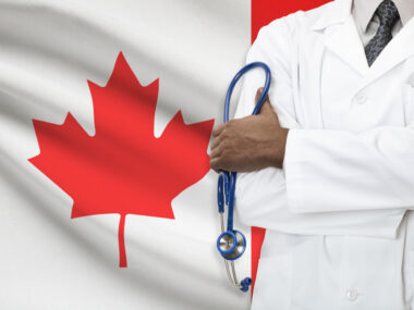 healthcare | Multiple Sclerosis News Today | Survey | Person in lab coat in front of Canadian flag and holding a stethoscope
