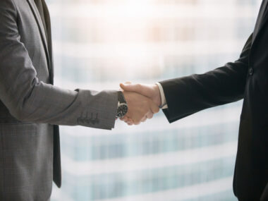 orelabrutinib | Multiple Sclerosis News Today | potential therapies | Close-up of hands of two business partners making deal