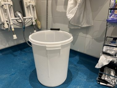 commode | Multiple Sclerosis News Today | John's wet room, replete with a large white bucket