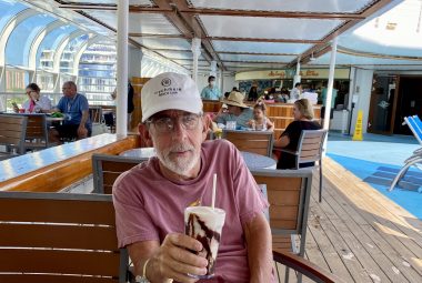 accessible cruise | Multiple Sclerosis News Today | Ed Tobias sips a drink on board a cruise ship