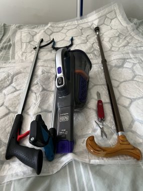 MS tools | Multiple Sclerosis News Today | The tools of John's "disabled trade" include two grabber sticks, a walking stick, a handheld vacuum, and a Swiss Army knife.