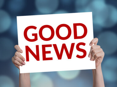 sharing good news | Multiple Sclerosis News Today | A stock photo of a person holding up a white sign that says 