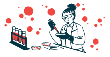 A scientist in a laboratory works with a petri dish and dropper, alongside a rack of four filled vials.