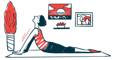 A woman performs a youga stretch on a mat.