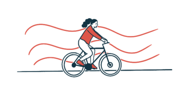 A woman is shown riding a bike.