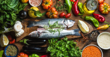 A variety of foods, including fish, leafy greens, tomatoes, garlic, and peppers.