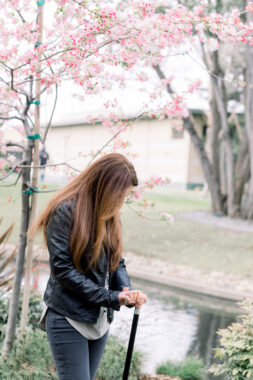 Sanam Saeedi stands beside a creek as she leans on a walking stick.