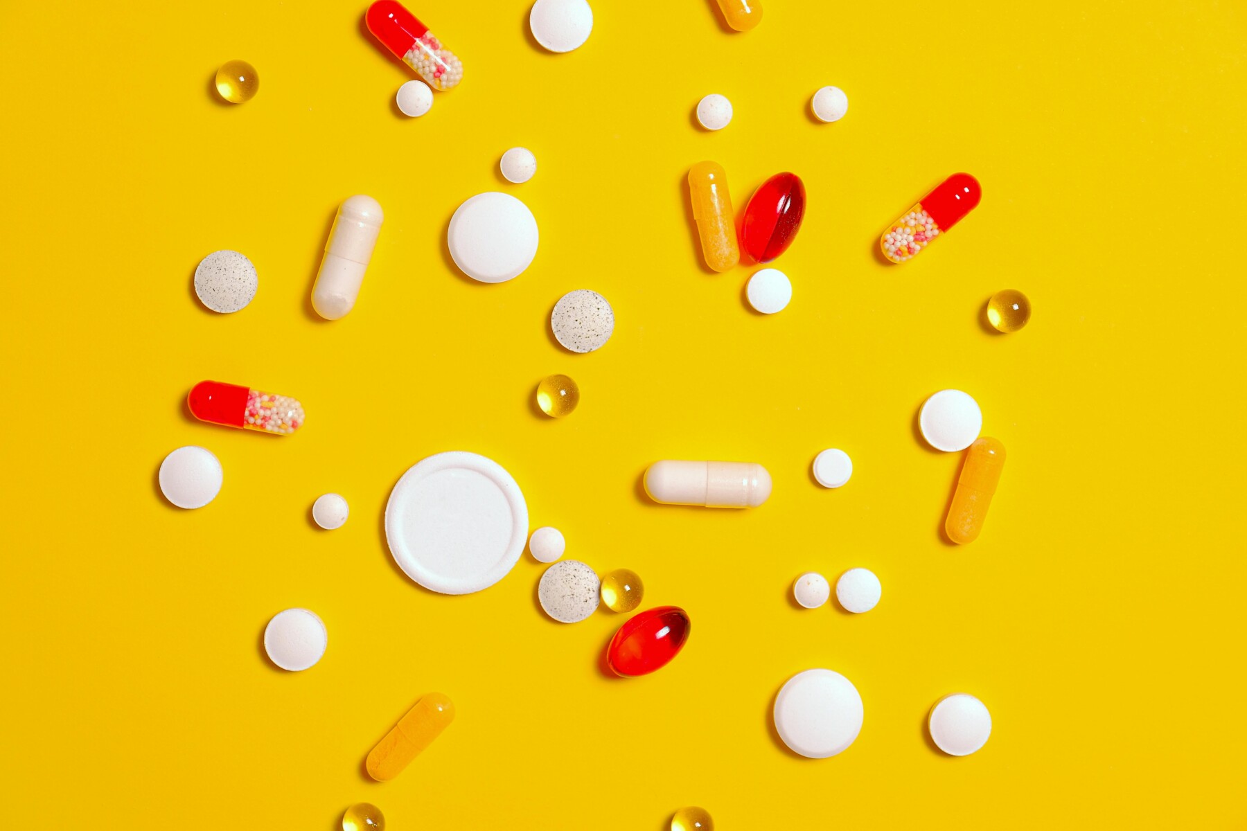 An array of pills and capsules is shown.