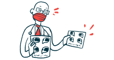 A doctor wearing a face mask holds a pair of imaging scans.