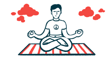 A person sits with crossed legs on a striped mat with hands in meditation position.
