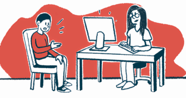 A patient sits with a doctor who is working at a computer.