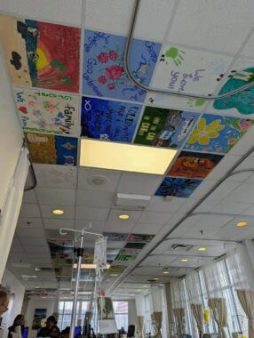 A view of a ceiling shows painted tiles