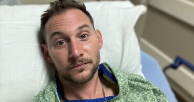 Chris Russell is seen in a hospital bed in this close-up photo.