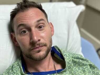 Chris Russell is seen in a hospital bed in this close-up photo.