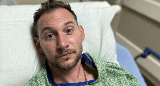 Chris Russell is seen in a hospital bed in this close-up photo.