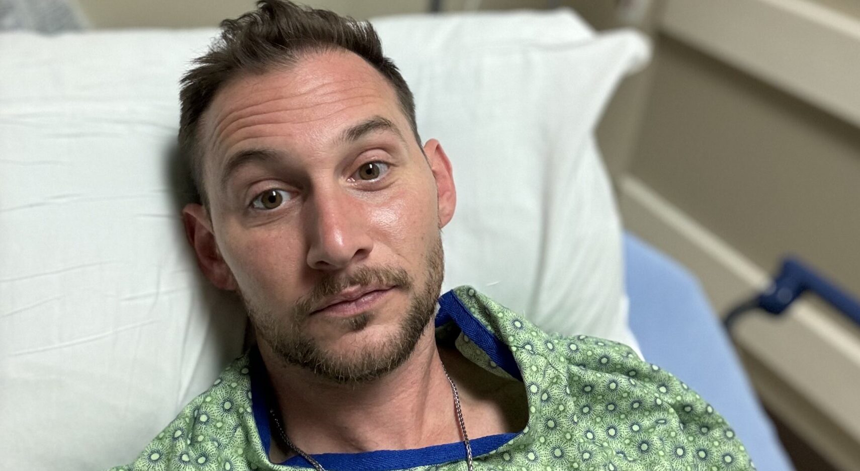 Chris Russell is seen in a hospital bed in this close-up photo.