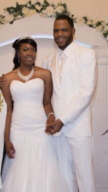 A young couple dressed in all white on their wedding day. 