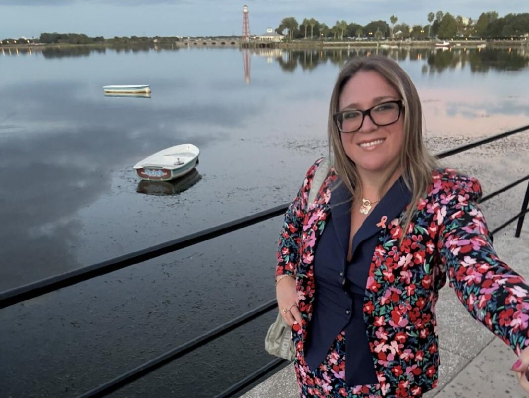 Brittany Boudreau, sporting an orange ribbon pin for MS awareness, takes a selfie while visiting Florida.