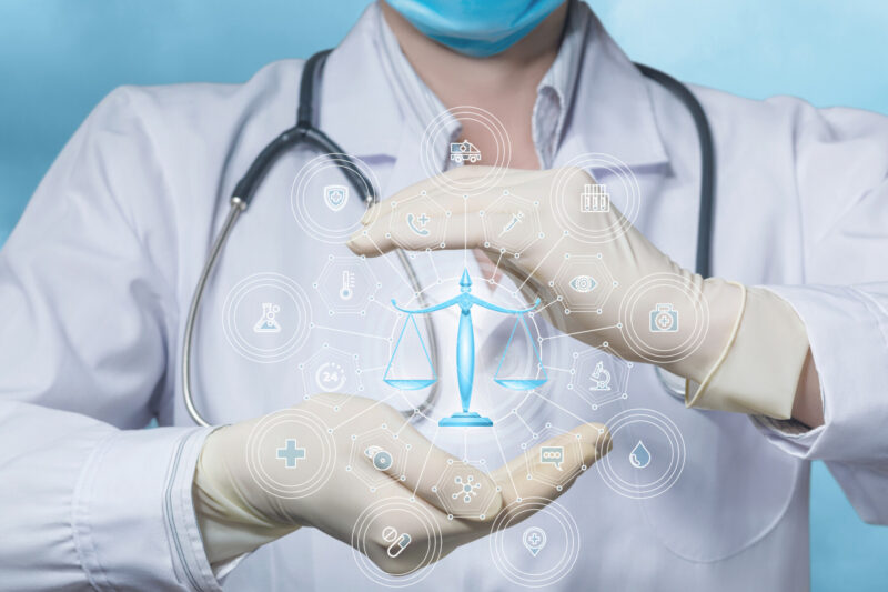 An image of a scale is superimposed over cupped hands of a person wearing a lab coat and stethoscope.