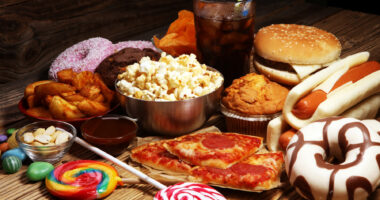 An array of highly-processed foods are seen on a table.
