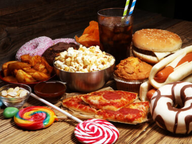 An array of highly-processed foods are seen on a table.