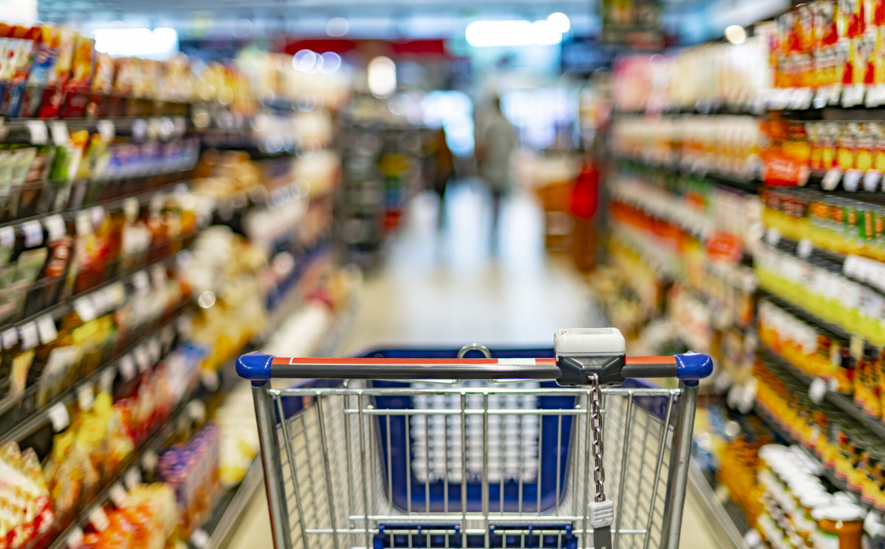 A shopping cart is shown in a grocery store aisle.