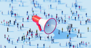 A crowd surrounding an oversized megaphone.
