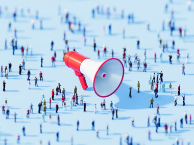 A crowd surrounding an oversized megaphone.