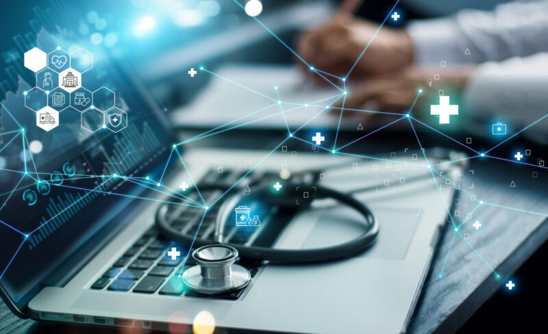 A graphic showing healthcare information is superimposed over an image of a stethoscope resting on the keyboard of an open laptop.