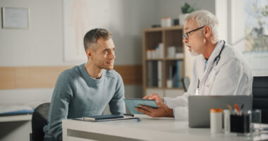 A doctor consults with a patient in their office.