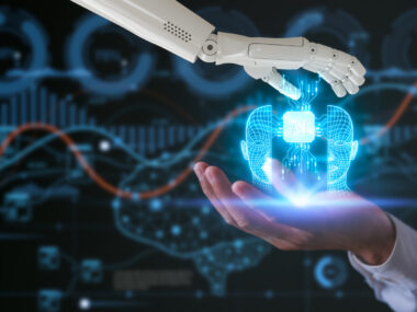 A robot hand and a human hand hold a virtual AI icon.