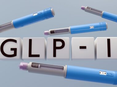 A 3D illustration of a gray syringe pen with the letters spelling 