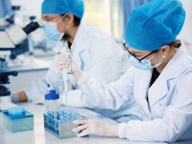 Scientists work on specimens in a laboratory.