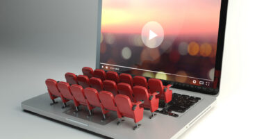 An image shows a laptop with rows of seats on the keyboard.