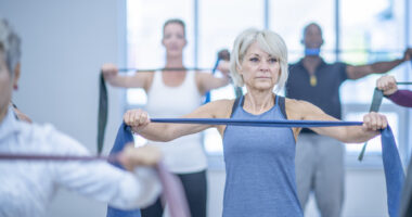 A photo shows women using resistance bands in an exercise class.