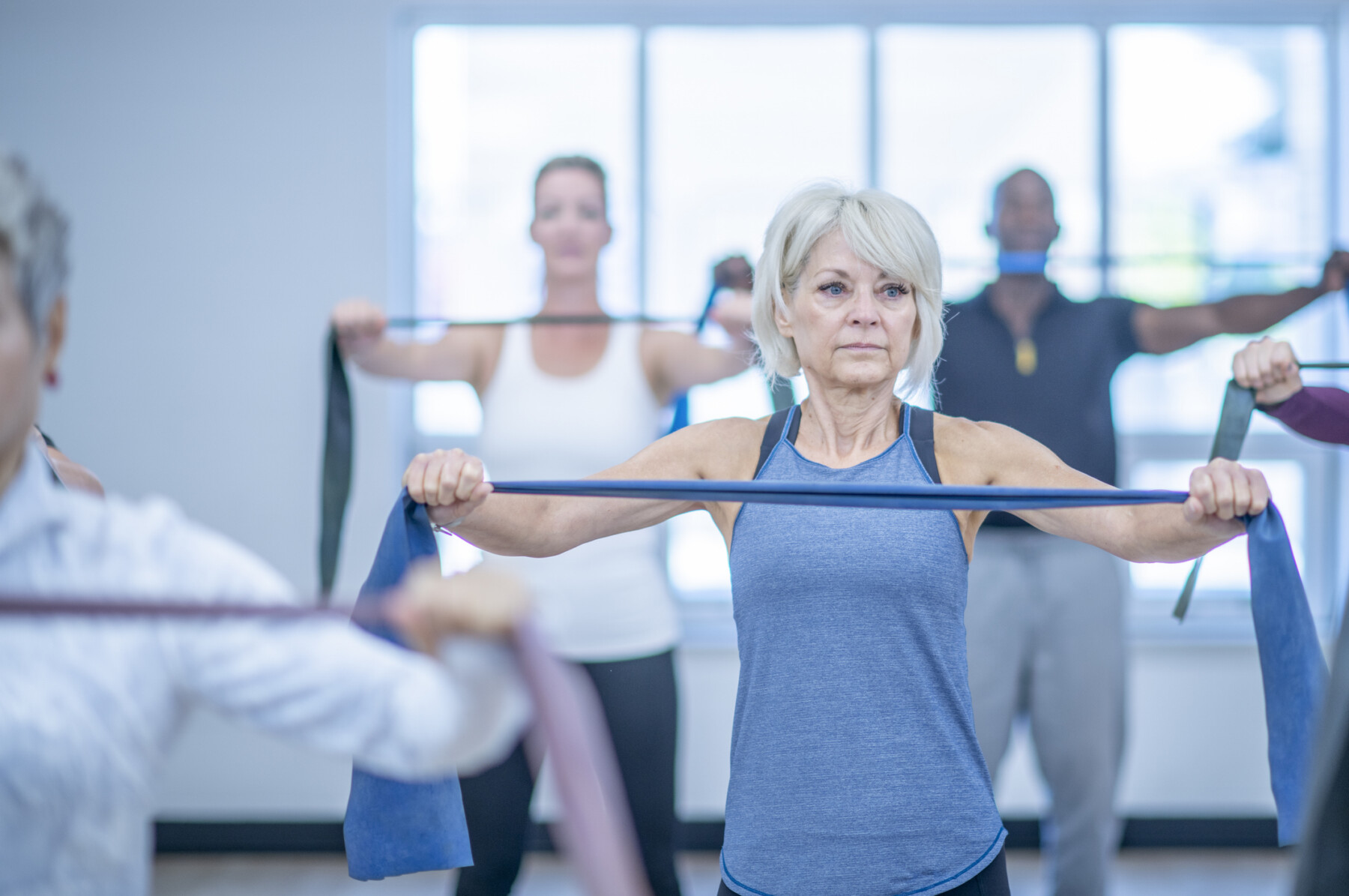 A photo shows women using resistance bands in an exercise class.