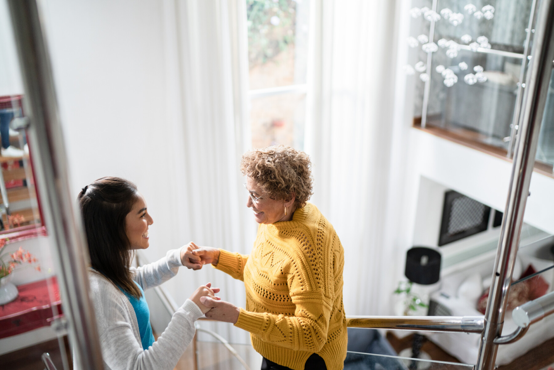 A photo shows a nurse supporting a woman while she practices walking.