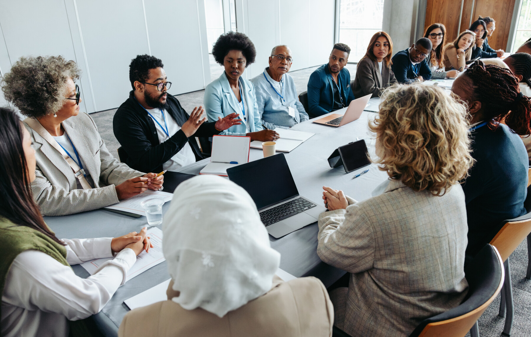 A group of people sit around a conference table.