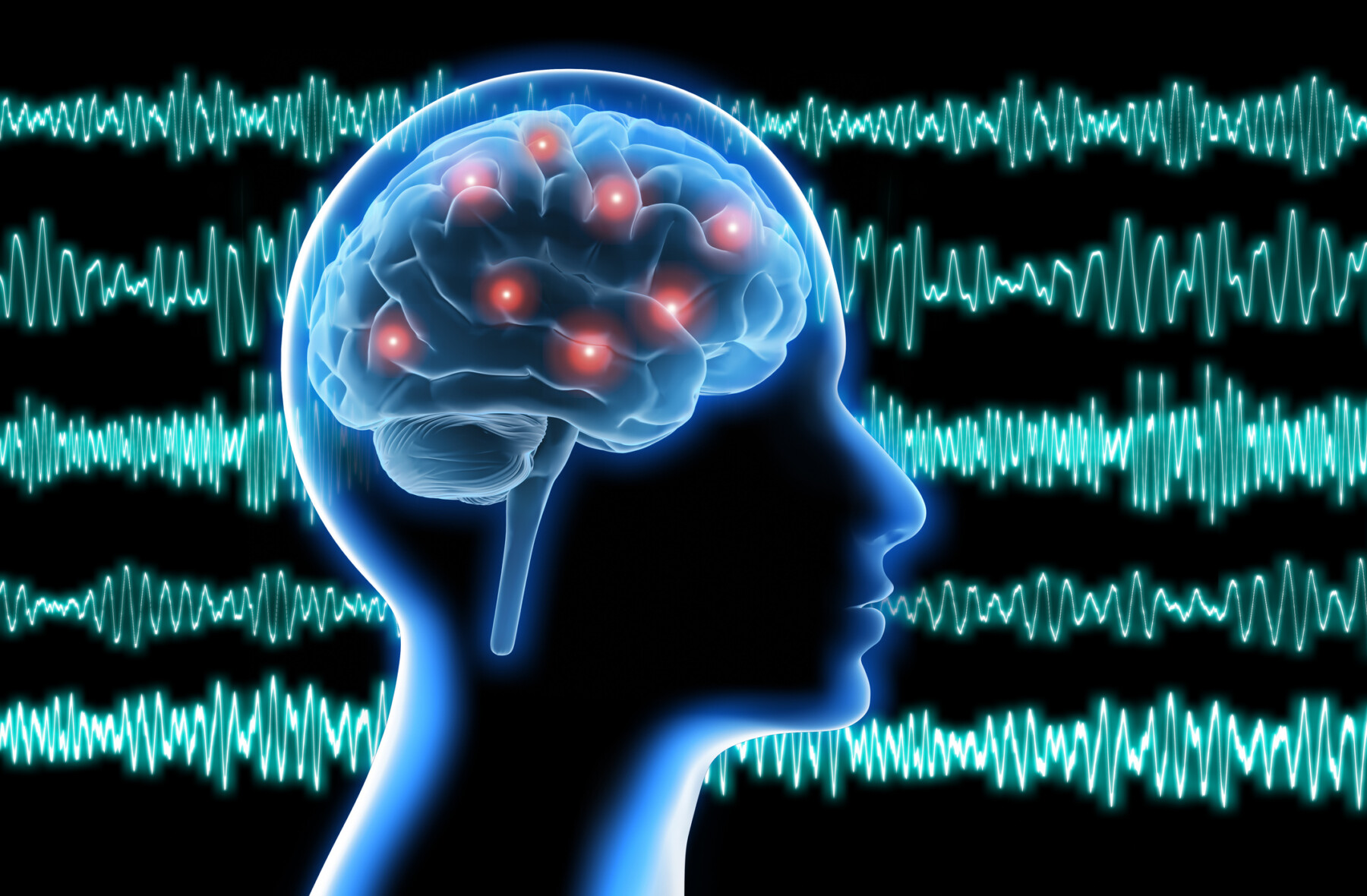 Against a backdrop of brain waves, the profile of a human head shows electrical activity in the brain.