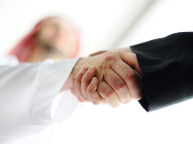 Two hands are shown shaking in agreement.