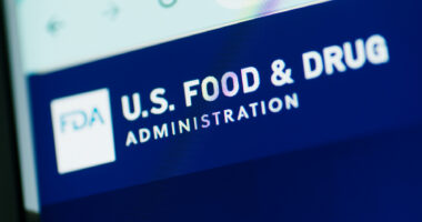 A close-up view of the U.S. Food and Drug Administration website shows the agency's name in white letters against a blue background.