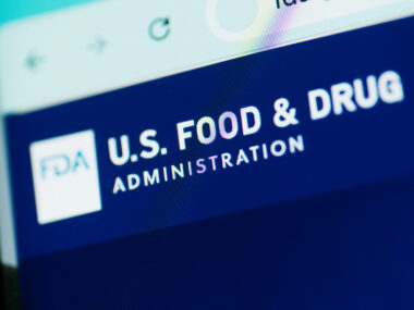 A close-up view of the U.S. Food and Drug Administration website shows the agency's name in white letters against a blue background.