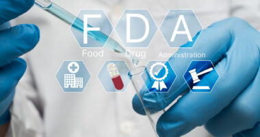 Icons reading F, D, A, and showing clinical trial elements are superimposed on an image of two gloved hands using a dropper to fill a vial.