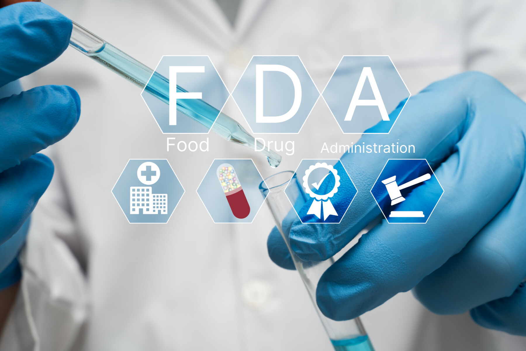 Icons reading F, D, A, and showing clinical trial elements are superimposed on an image of two gloved hands using a dropper to fill a vial.