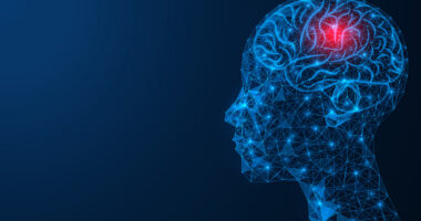 A red spot is seen in a brain within a human head constructed of blue lines and bright dots.