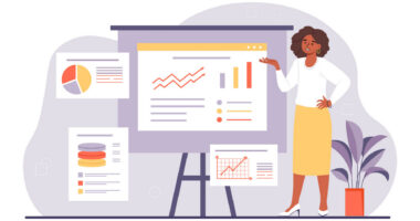 A woman stands at an easel showing charts and graphs.