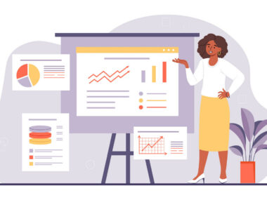 A woman stands at an easel showing charts and graphs.