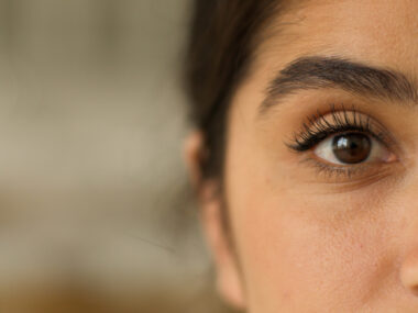 A close-up of a woman's face highlights one of her eyes.